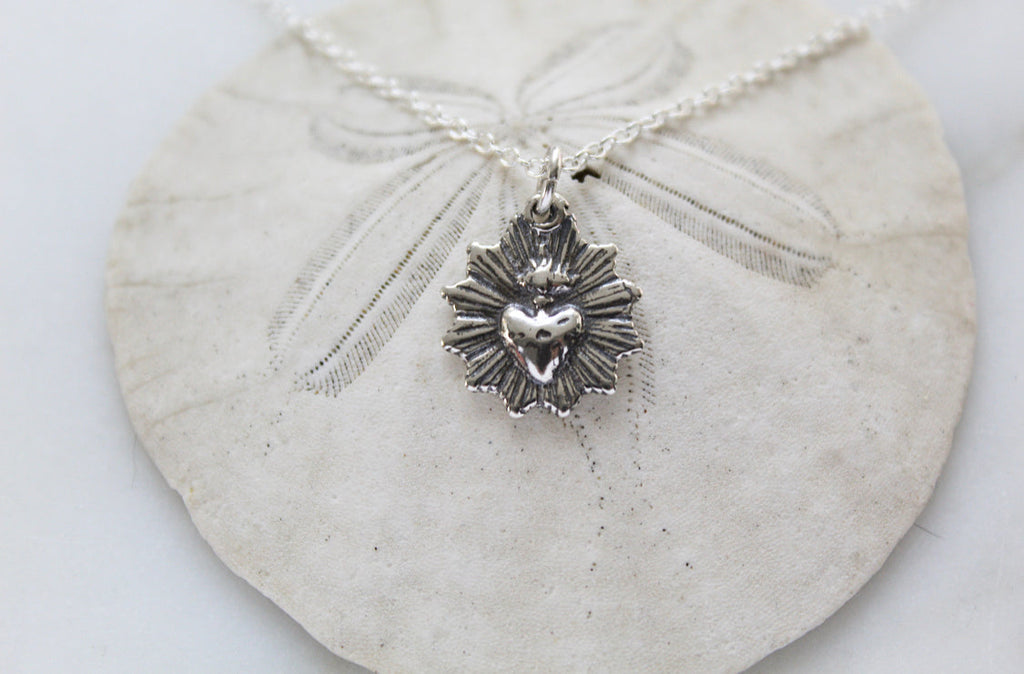 Oxidized silver heart pendant necklace on chain with scalloped radiating charm