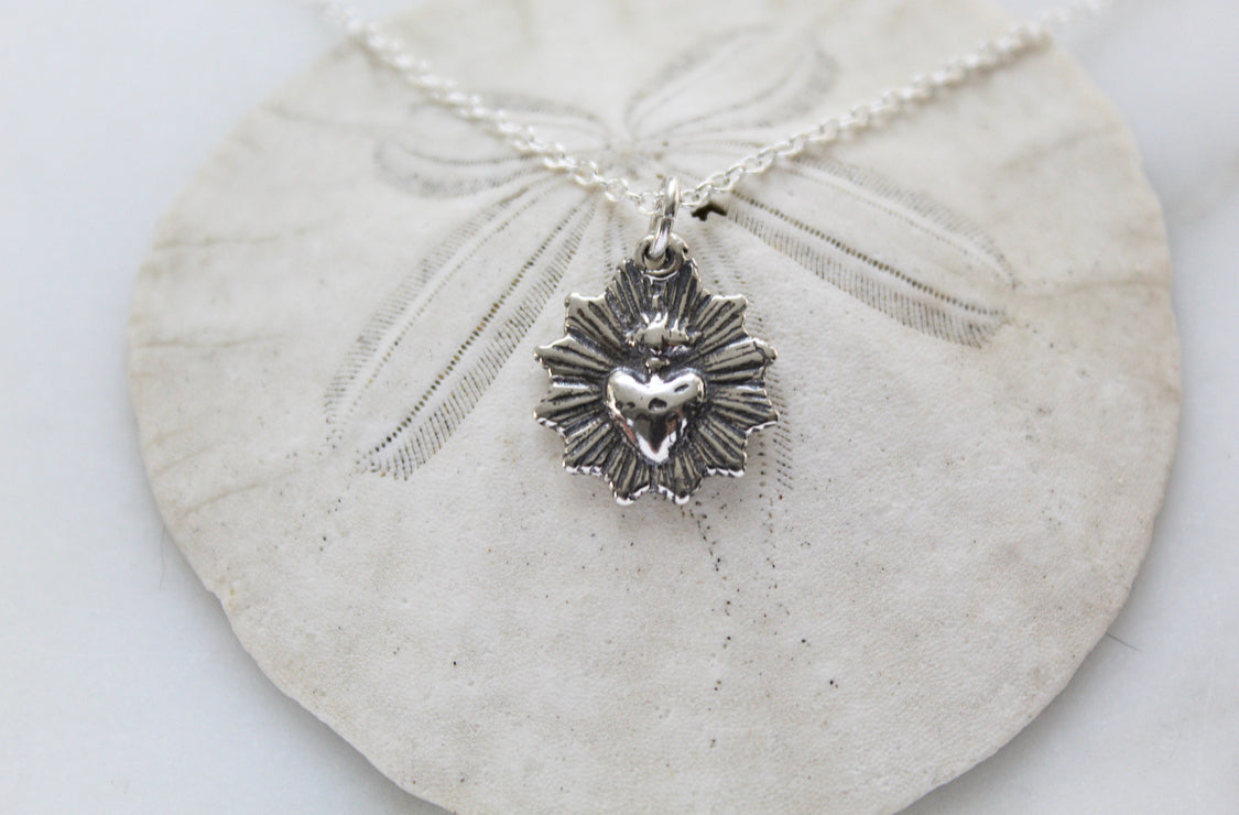 Oxidized silver heart pendant necklace on chain with scalloped radiating charm