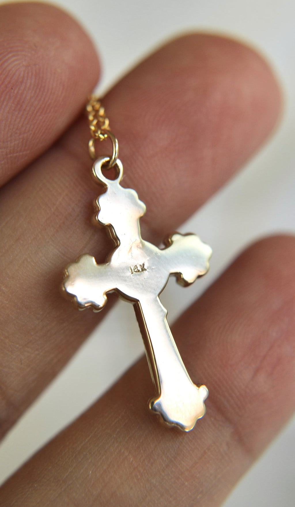 14k gold crucifix pendant with front detail and '14k' stamp