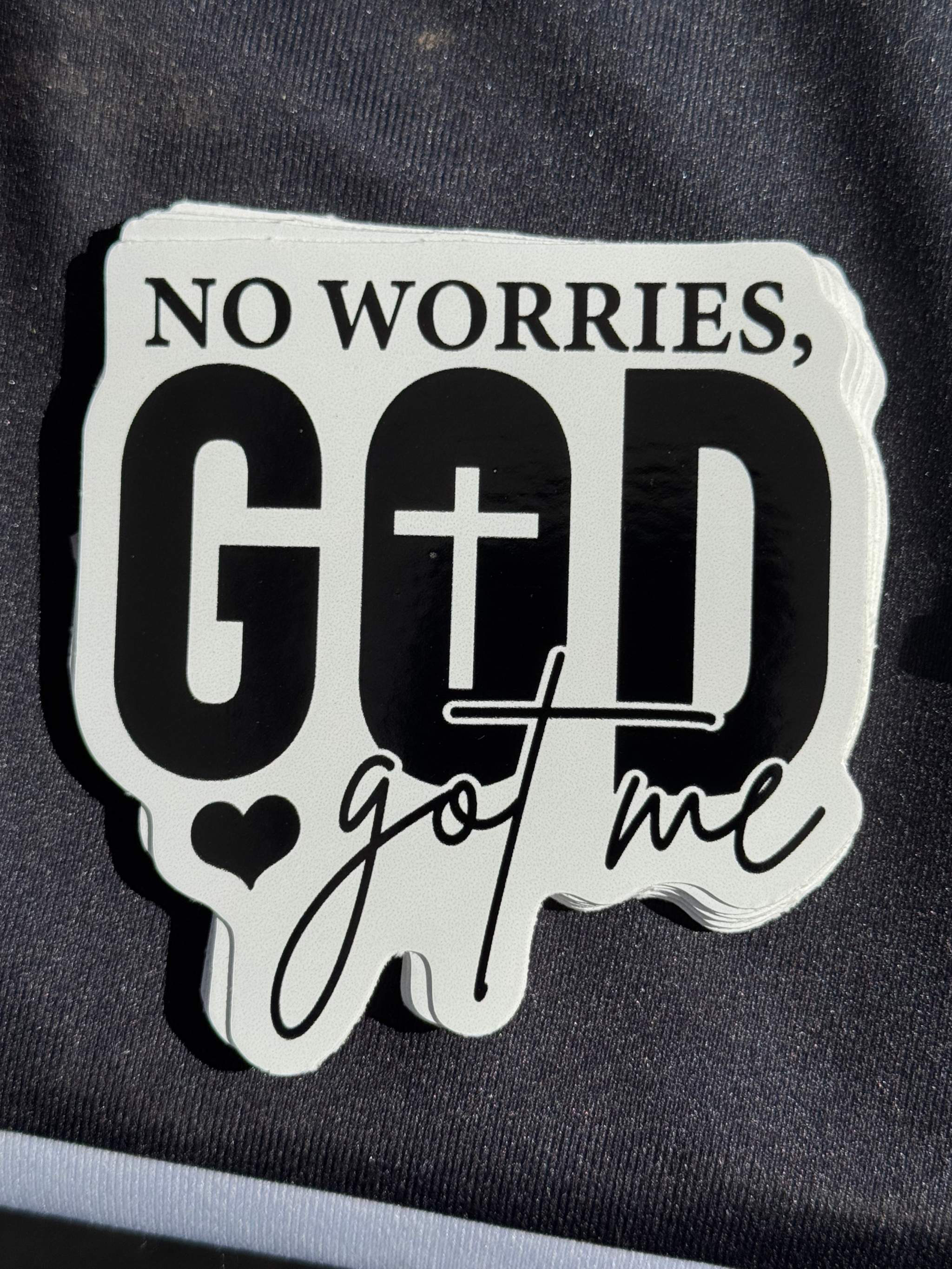 Vinyl sticker reading 'NO WORRIES, GOD' with cross and 'got me' text
