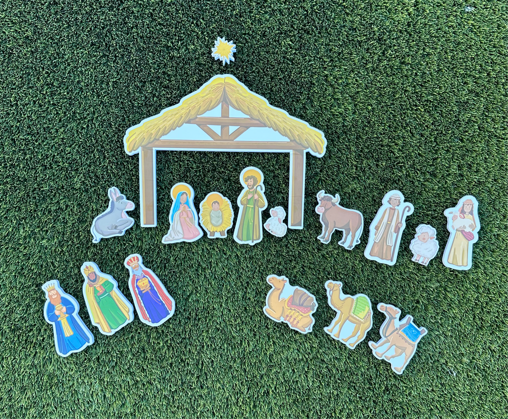 Nativity bath toy set with stable and character cutouts arranged on green turf