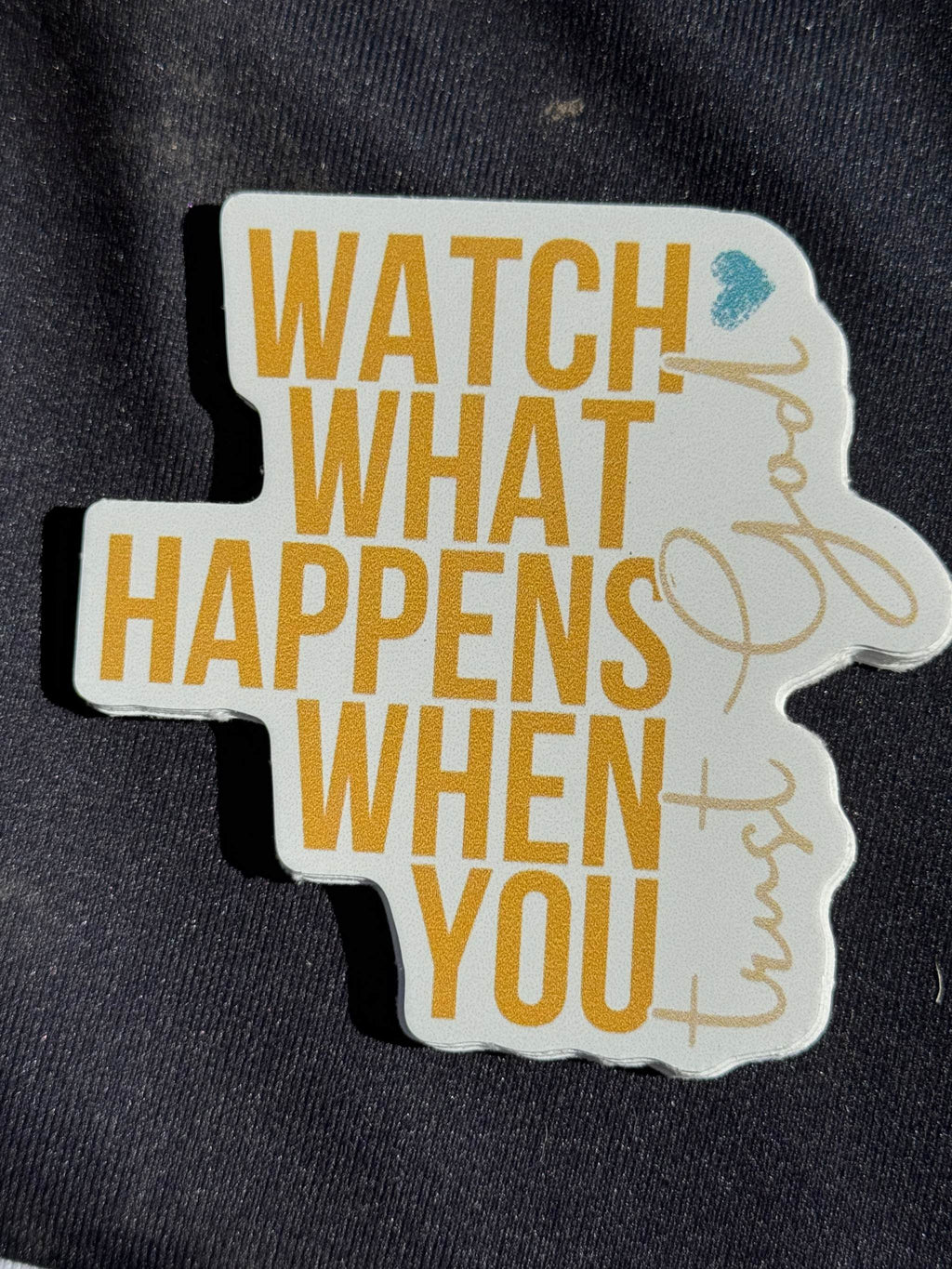 Vinyl sticker reading 'WATCH WHAT HAPPENS' and 'WHEN YOU' in yellow and blue
