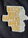 Vinyl sticker reading 'WATCH WHAT HAPPENS' and 'WHEN YOU' in yellow and blue