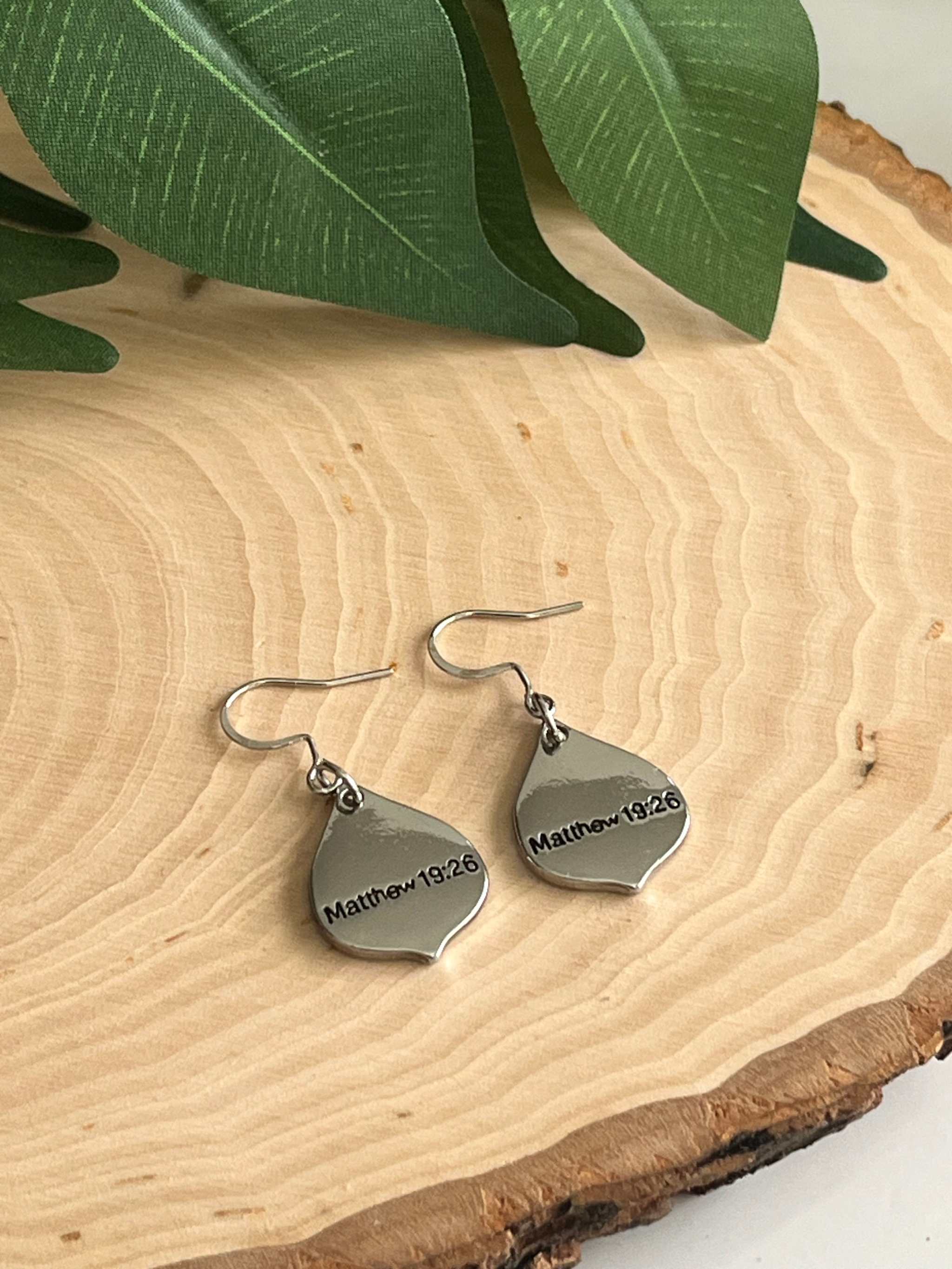 Silver teardrop charm earrings with hooks; “Matthew 19:26” engraved.