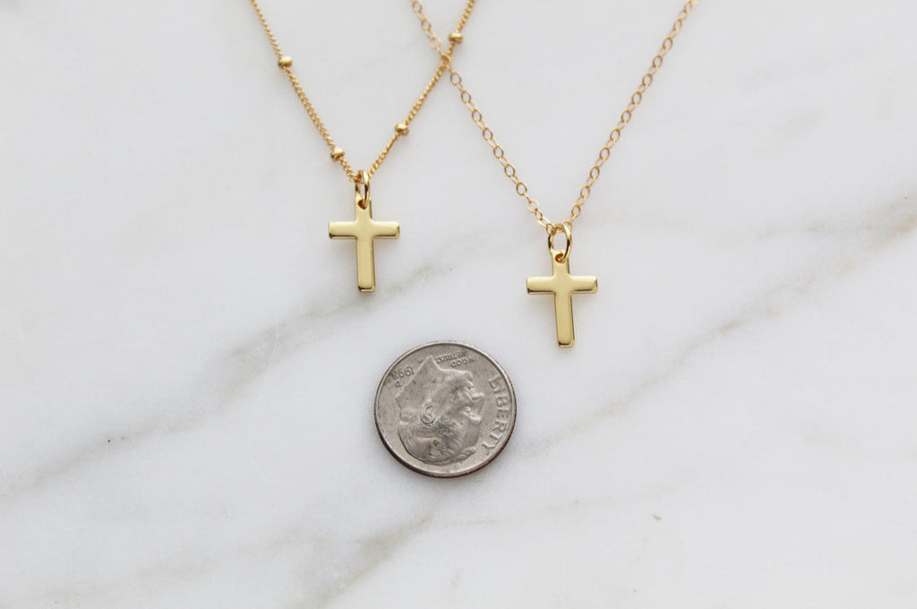 Gold cross pendant necklaces on thin chains, small cross charms with coin for scale