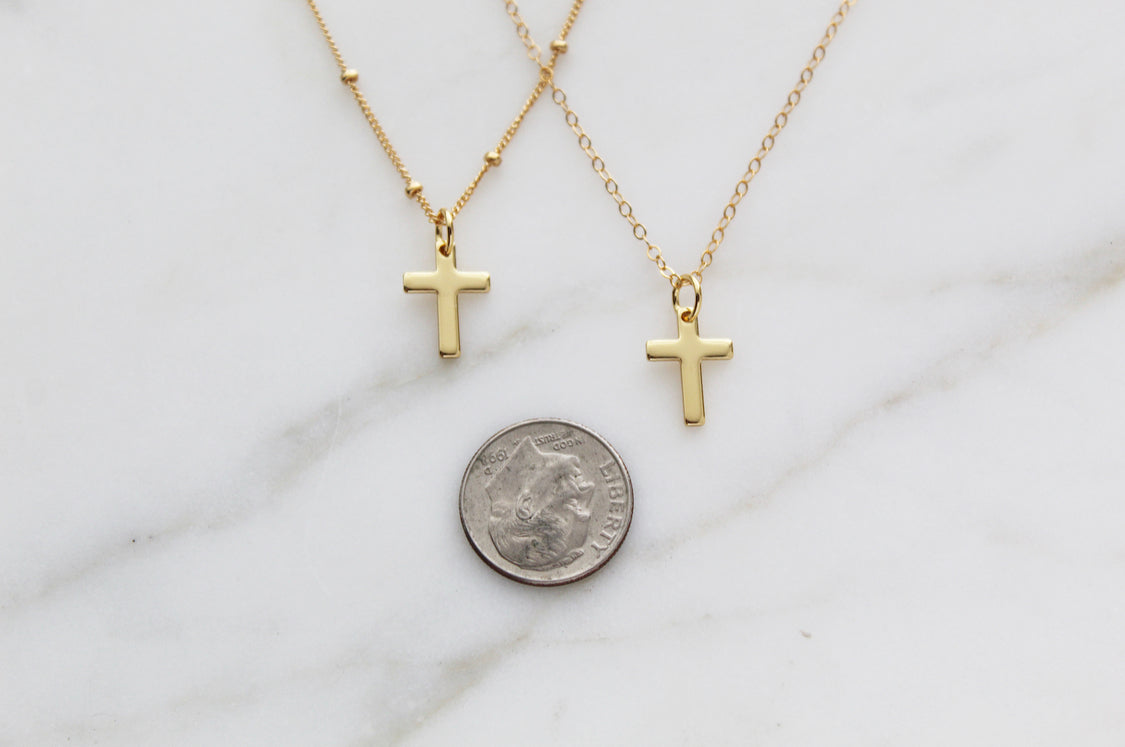 Gold cross pendant necklaces on thin chains, small cross charms with coin for scale