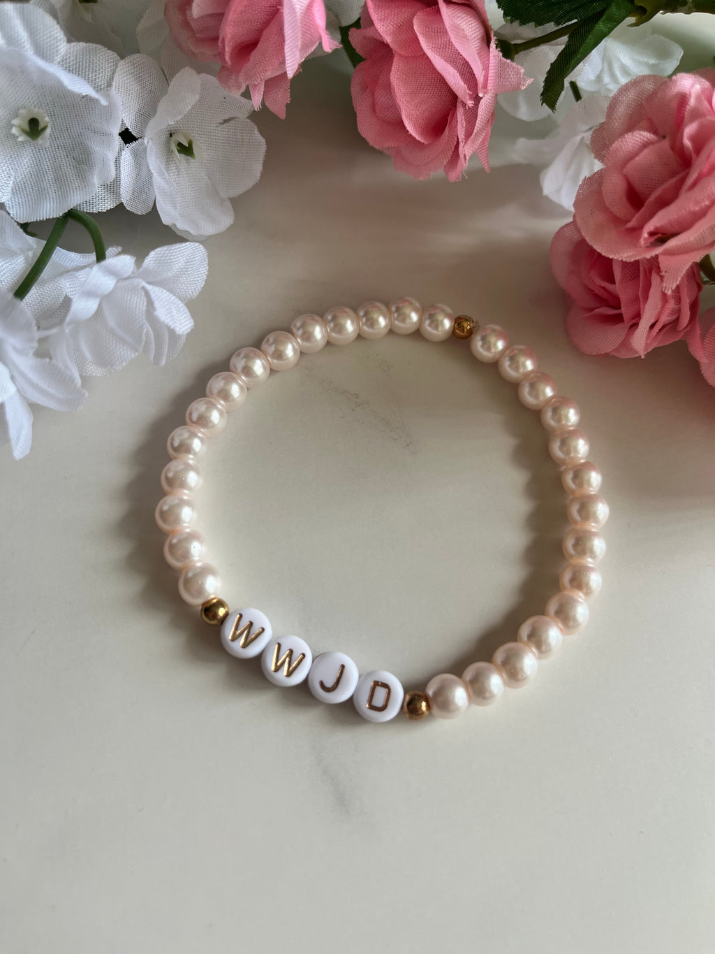 Pink pearl bead bracelet with WWJD letter beads and small gold detail