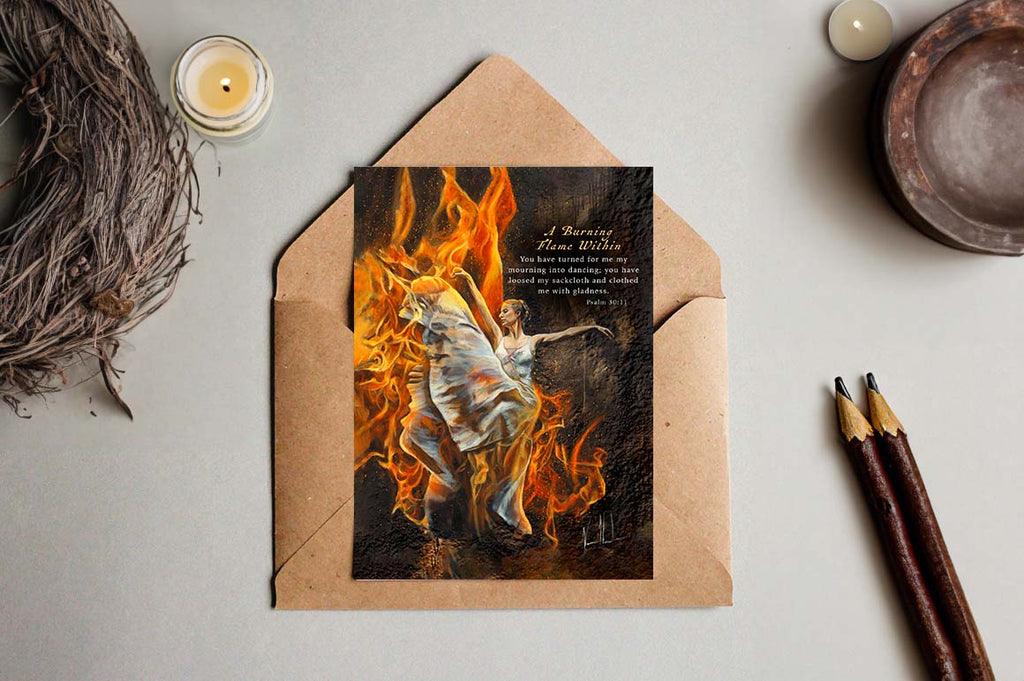 Flame-themed greeting card with angel figure on artwork, in kraft envelope