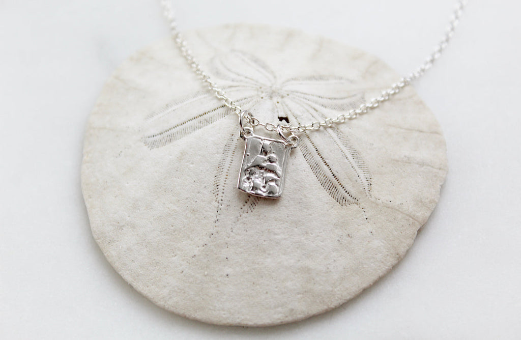 Sterling silver scapular necklace with engraved rectangular pendant centered on fine chain