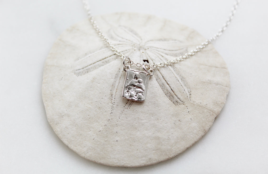 Sterling silver scapular necklace with engraved rectangular pendant centered on fine chain