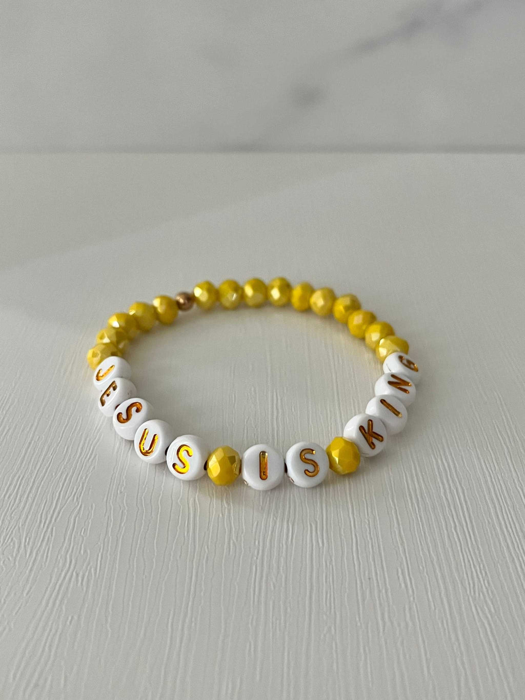 Bead bracelet with white letter beads and yellow round beads, JESUS IS KING