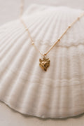 Gold heart charm necklace with tiny sacred heart pendant on a fine chain