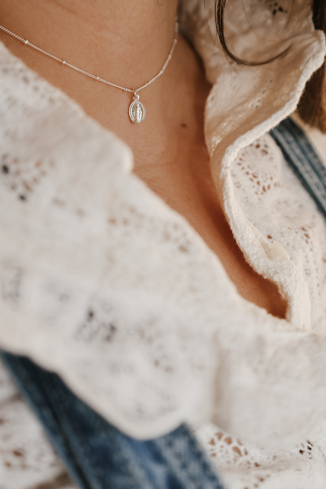 Miraculous medal necklace on a thin chain with oval pendant, silver-tone