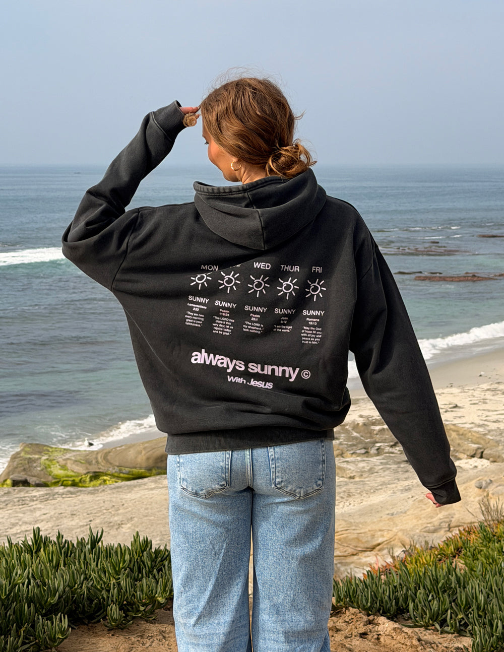 Unisex charcoal hoodie with back graphic text and sun icon, large hood, pouch pocket