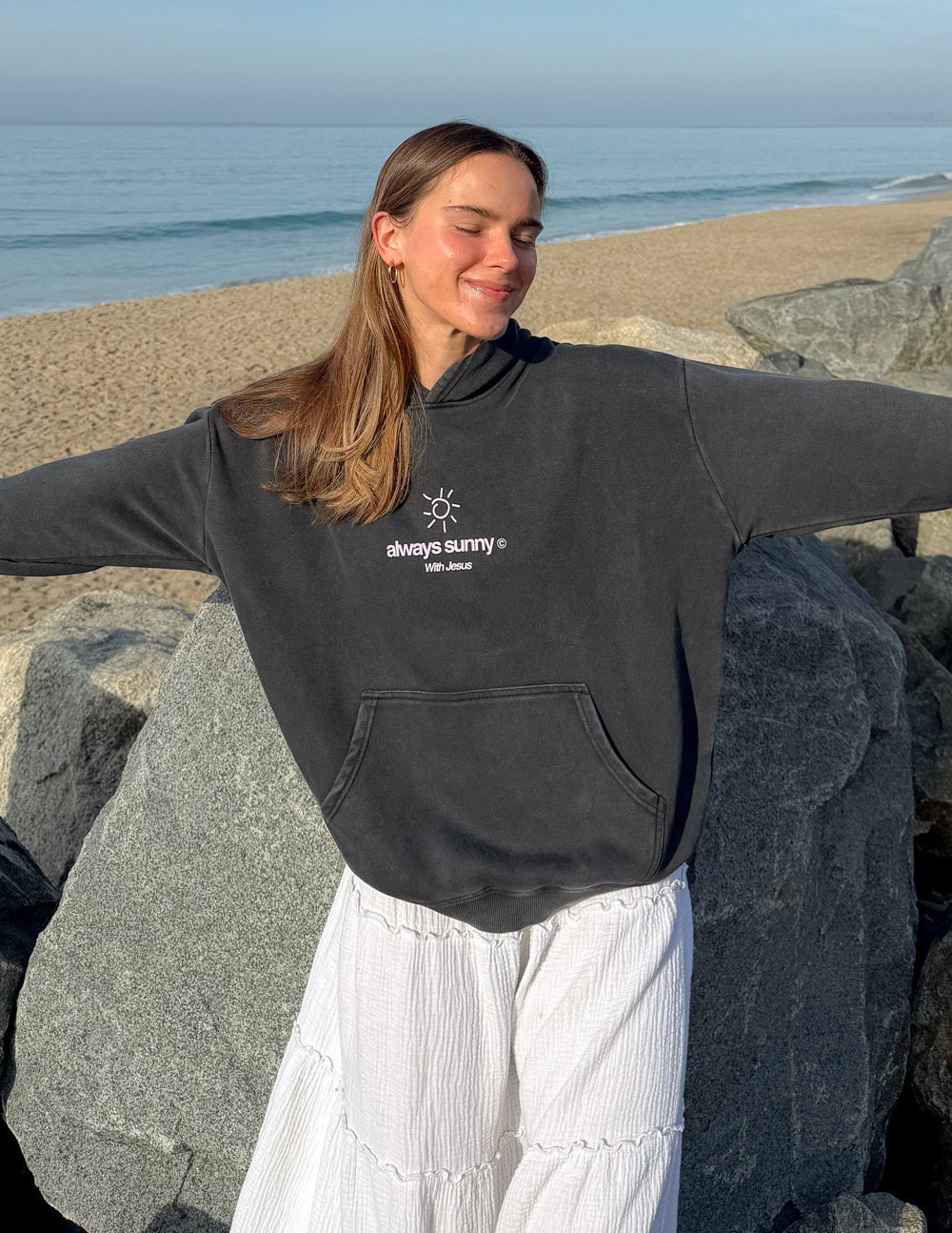 Unisex charcoal hoodie with front sun icon and “always sunny” text, kangaroo pocket