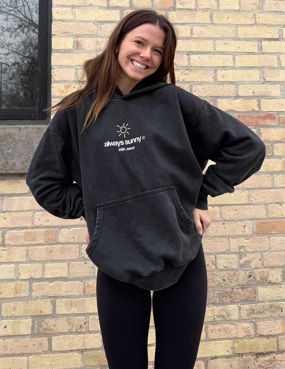 Unisex charcoal hoodie with front sun icon and “always sunny” logo, hood and pouch pocket