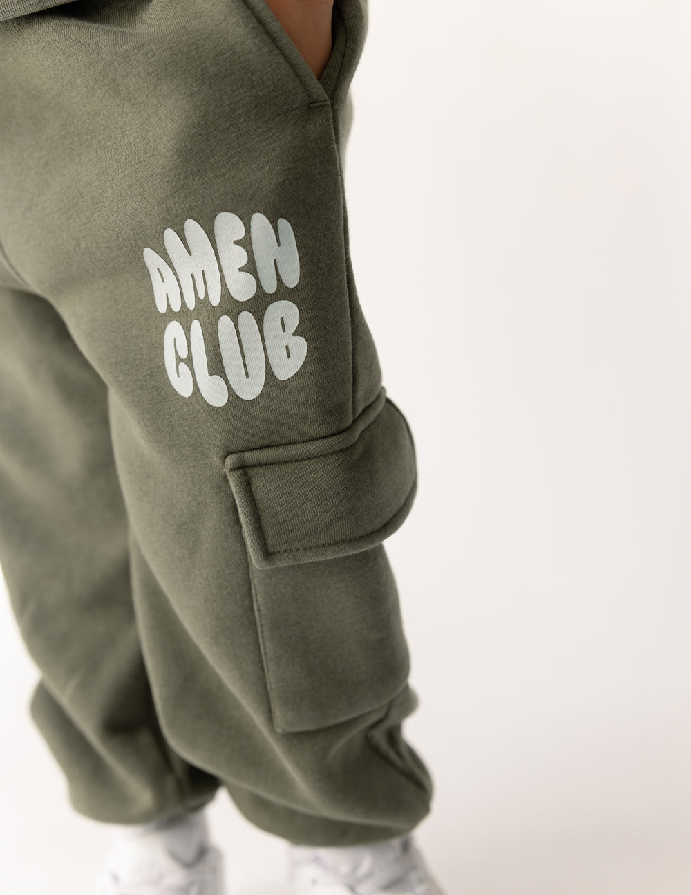 Kids cargo sweatpants with AMEN CLUB logo on thigh and flap cargo pocket