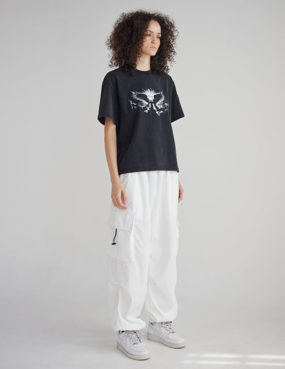 Black heavyweight T-shirt with white winged angel graphic, relaxed drape