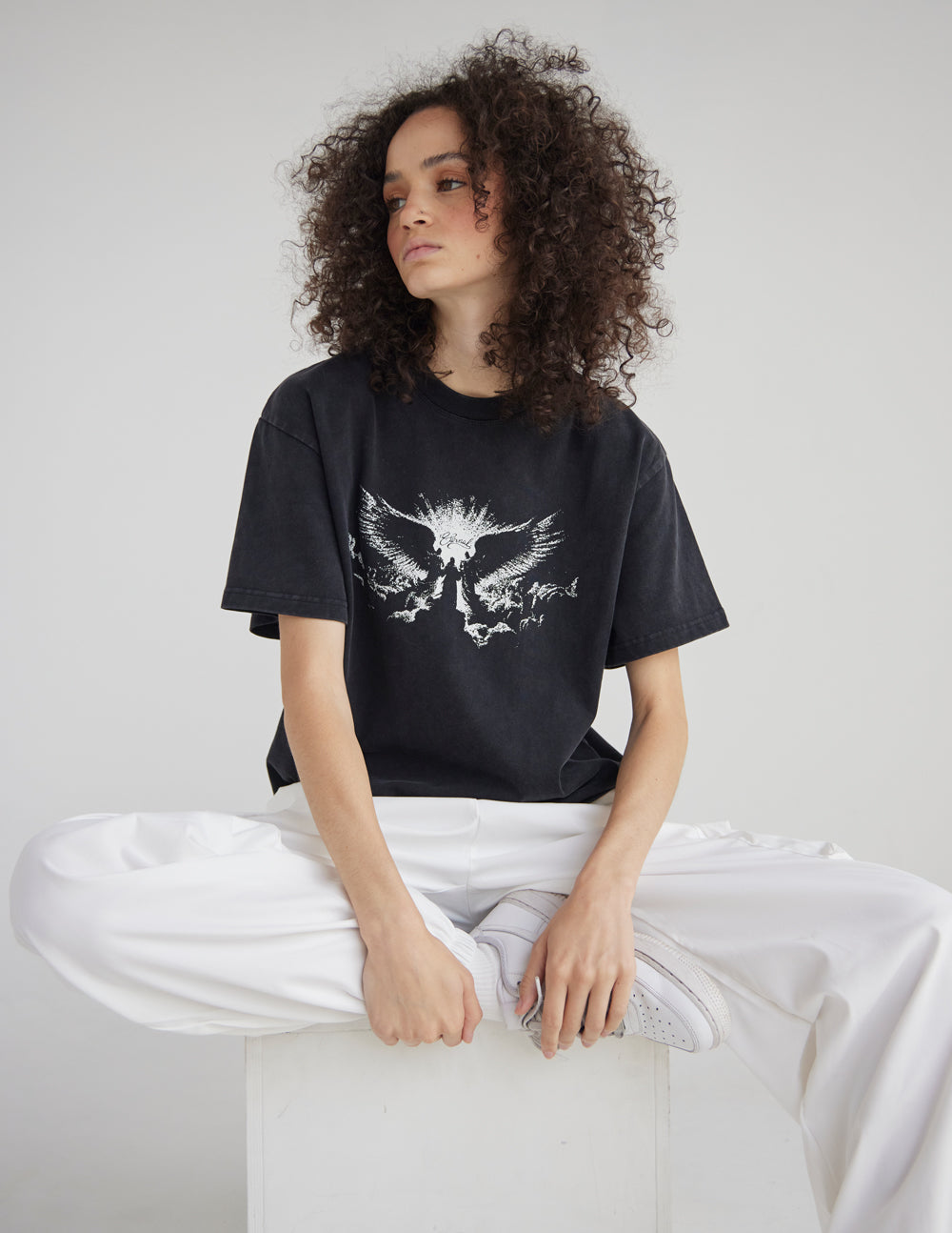 Black heavyweight T-shirt with white winged angel graphic, crew neckline