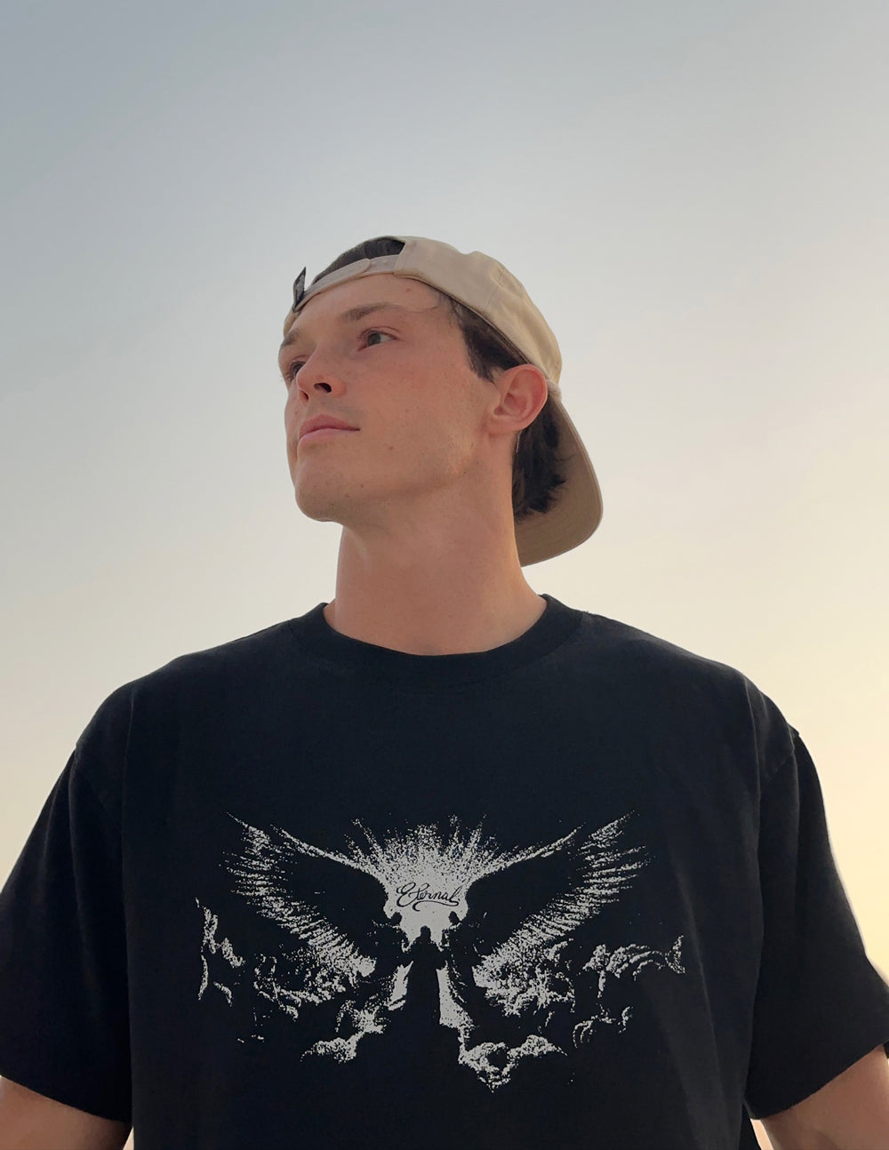 Black heavyweight T-shirt with white winged angel graphic on the chest