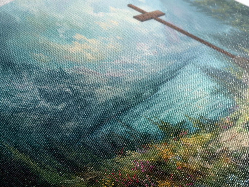 Close-up of canvas texture with painted mountain lake tones and a wooden cross