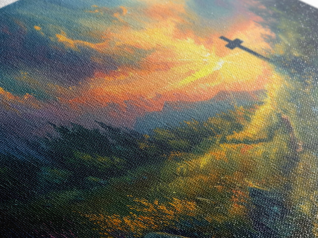 Close-up of textured Christian canvas showing a dark cross over a sunset glow