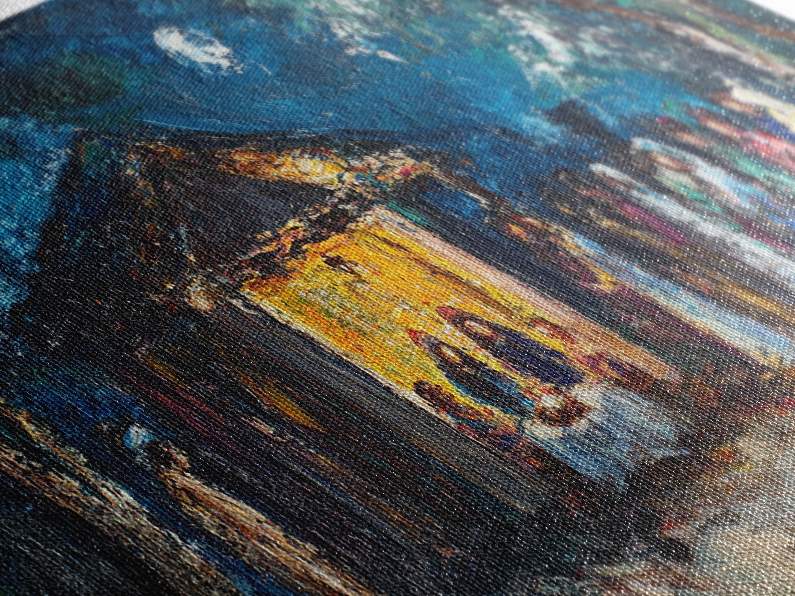 Close-up of textured brushstrokes in blue sky and yellow building on a canvas print