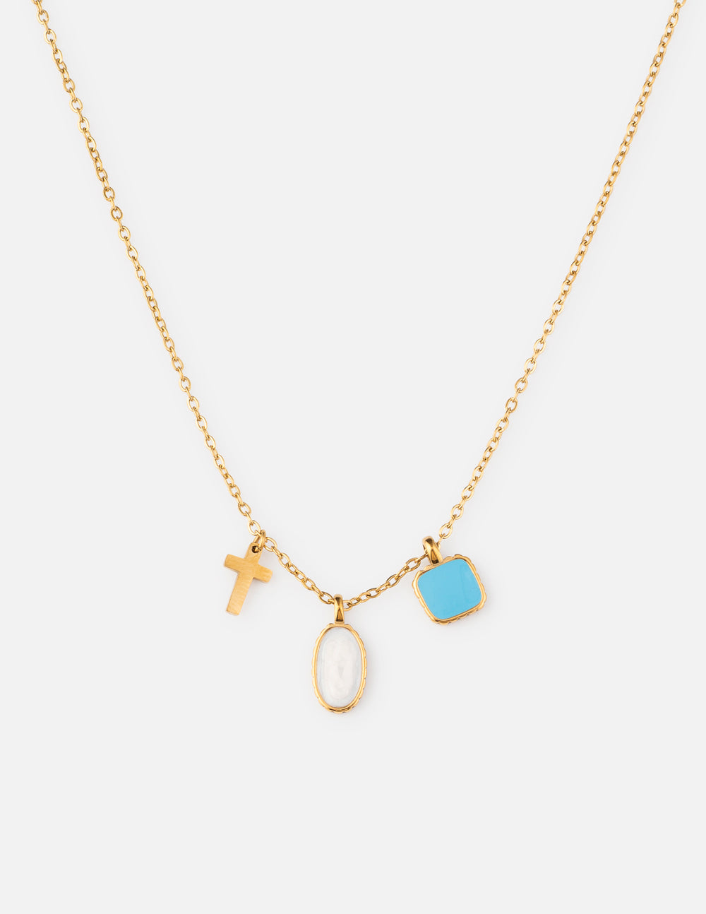 Gold charm link necklace with cross, white oval, and blue square pendants