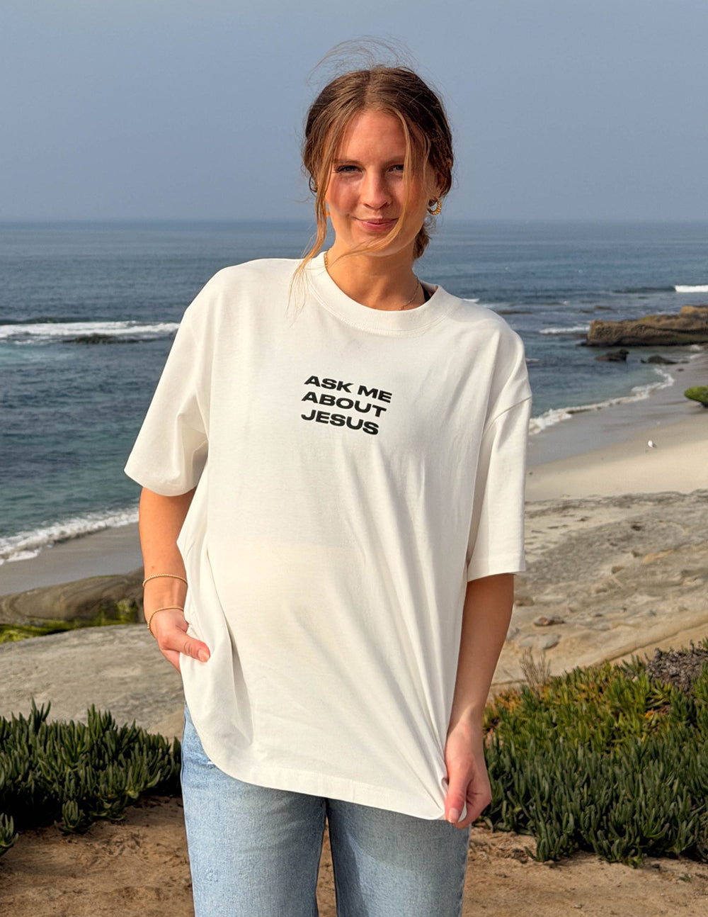 White heavyweight T-shirt with black chest text: Ask Me About Jesus, relaxed fit.