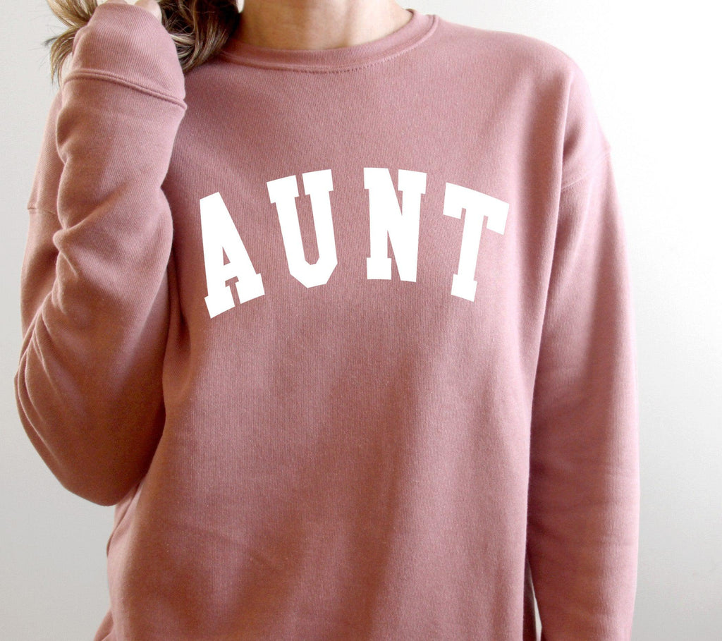 Mauve crewneck sweatshirt with large white "AUNT" graphic on the front