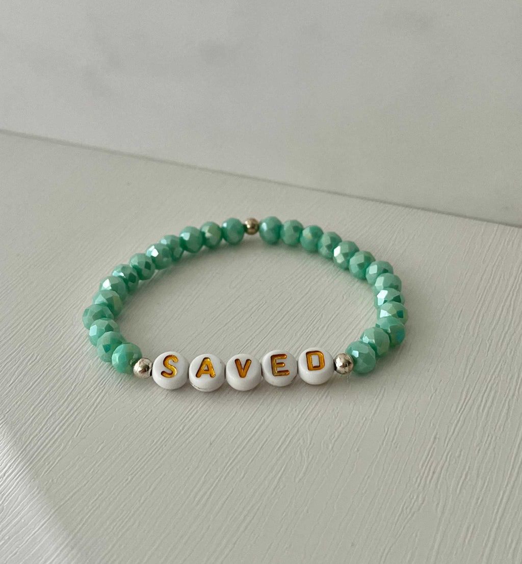 Mint green beaded bracelet with 'SAVED' letter beads and gold-tone spacers