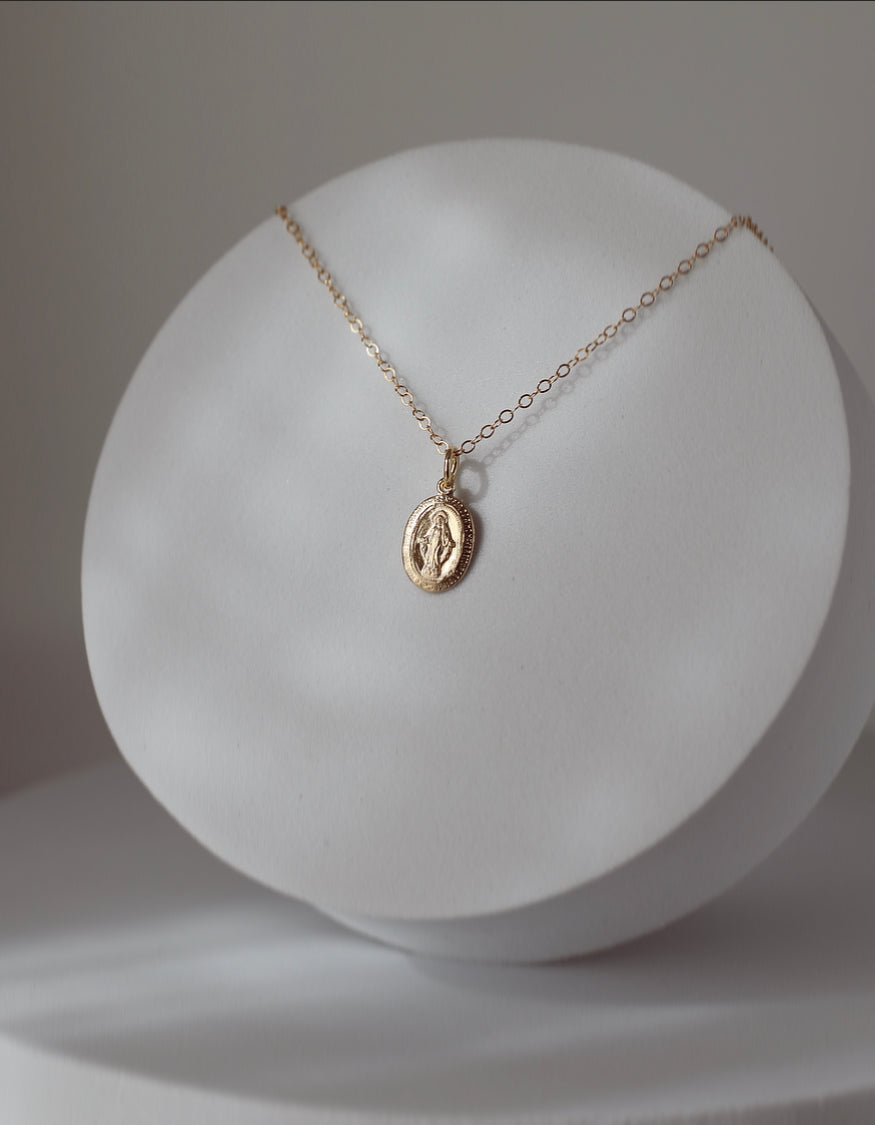 Silver-tone oval medal necklace on a fine chain
