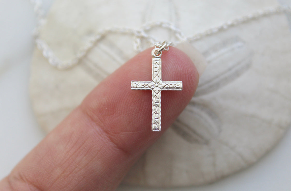 Sterling silver cross pendant necklace, close-up on ornate center cross
