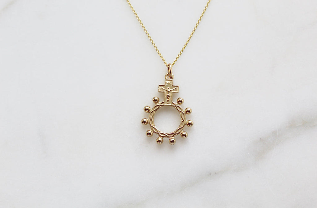 14k gold rosary bead necklace pendant featuring cross and circular bead halo ring