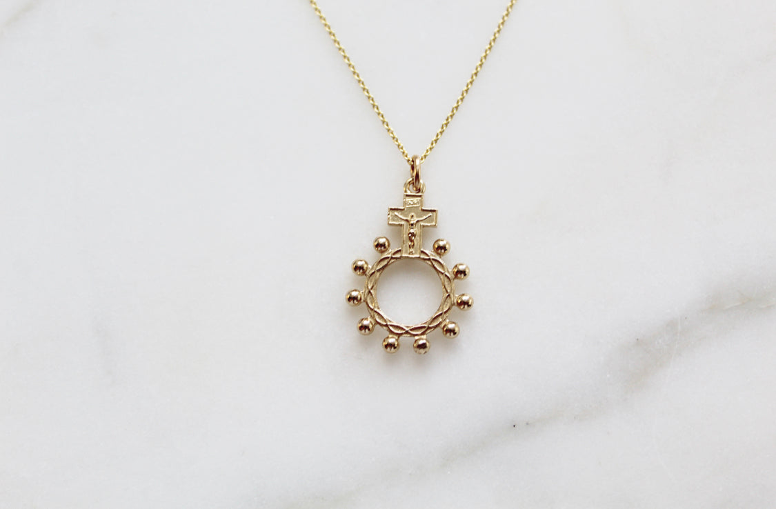 14k gold rosary bead necklace pendant featuring cross and circular bead halo ring