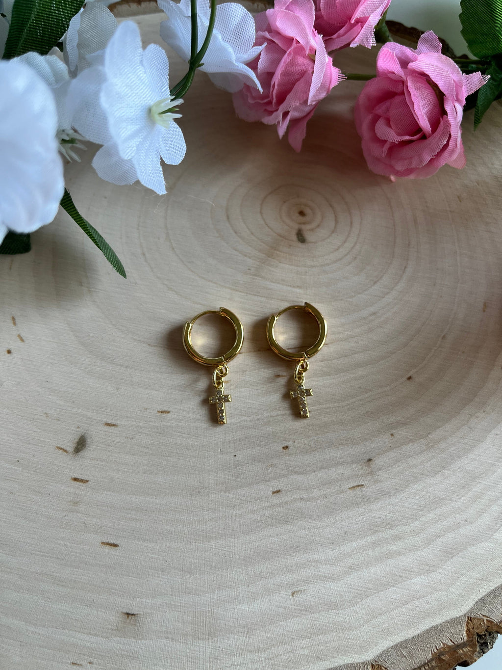Gold hoop earrings with cross drop charms, centered