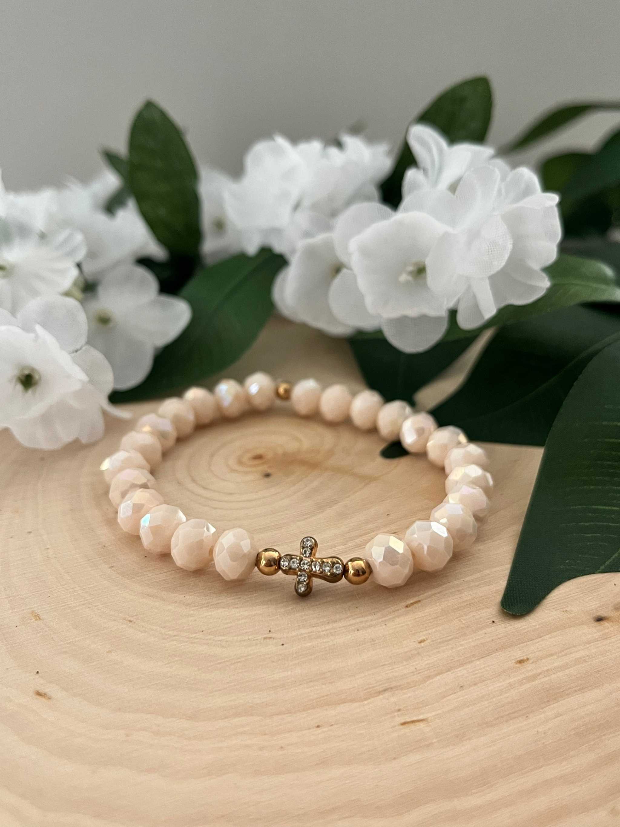 Beaded cross bracelet with light pink faceted beads and small rhinestone cross