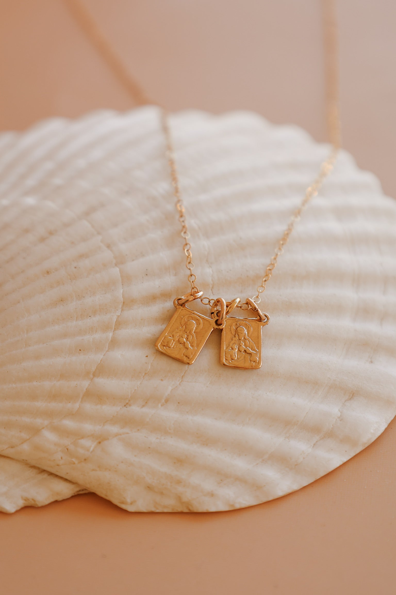 Scapular charm necklace with two rectangular pendant charms on a gold chain