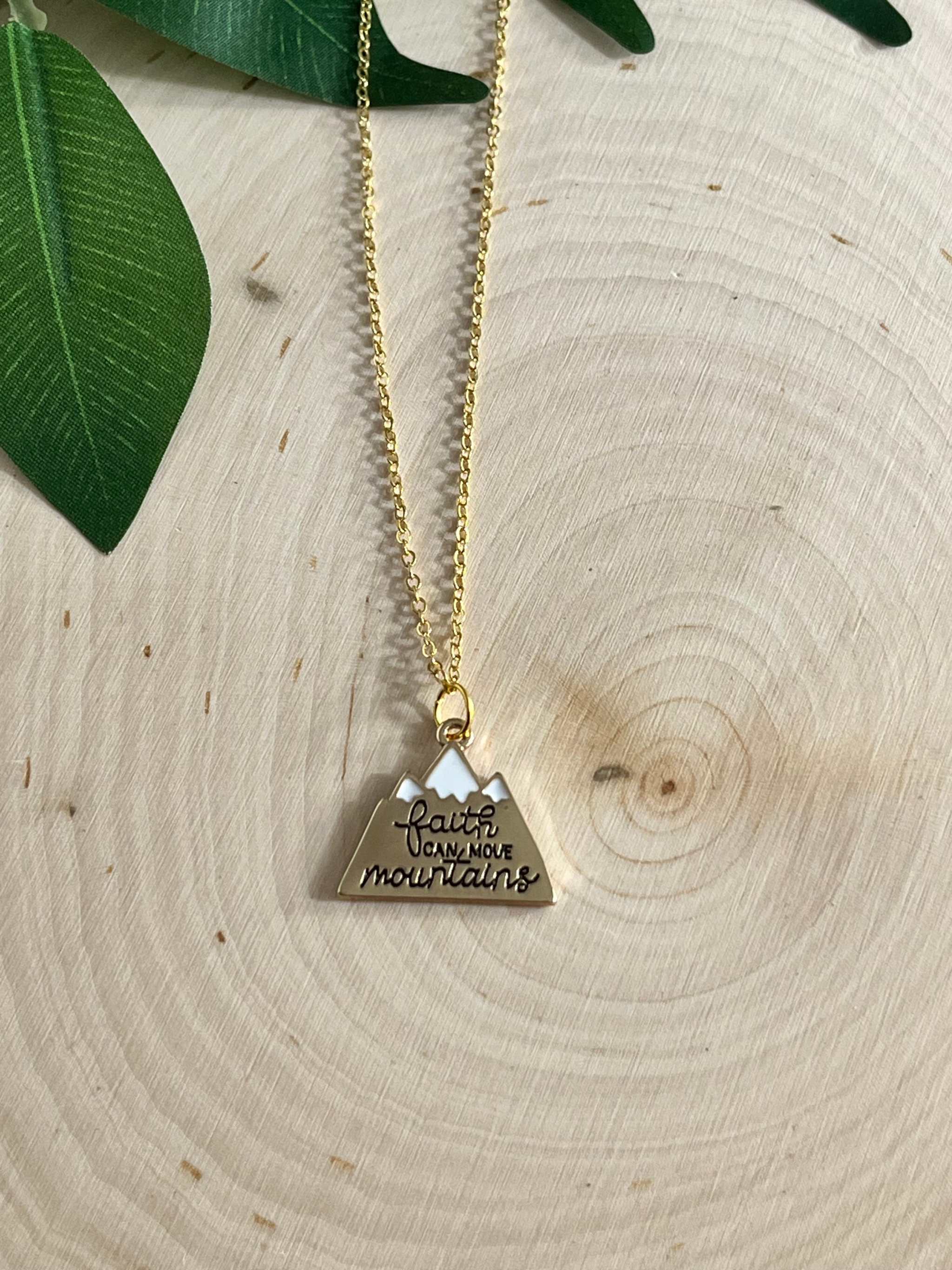 Gold chain necklace with heart-shaped pendant engraved with scripture text