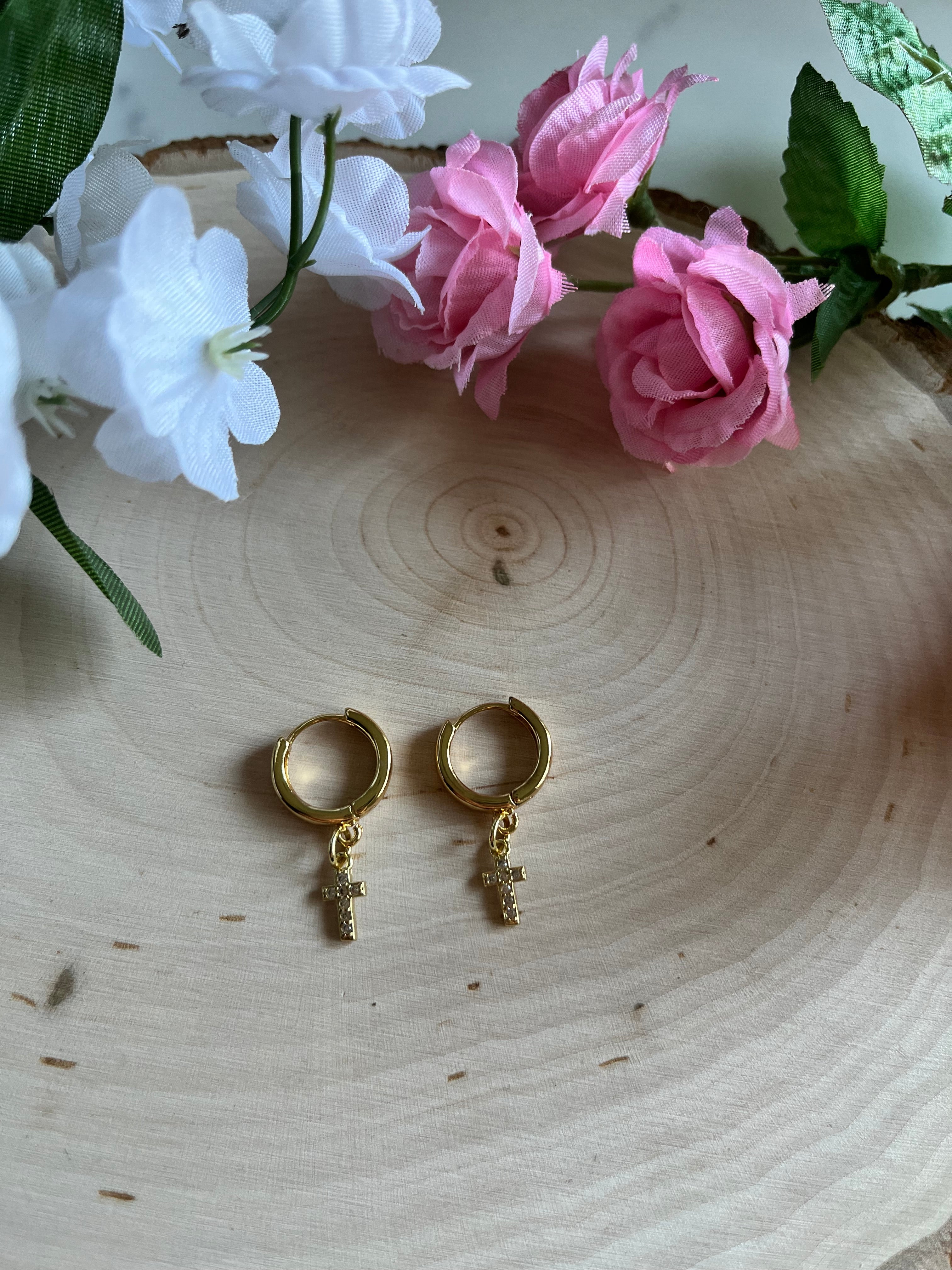 Gold hoop earrings with cross drop charms, symmetrical pair