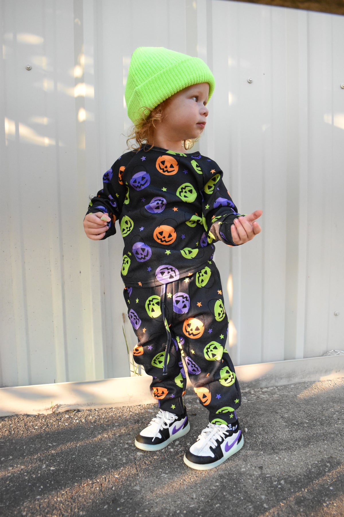 Kids waffle pajama set in dark navy with colorful jack-o'-lantern and ghost print