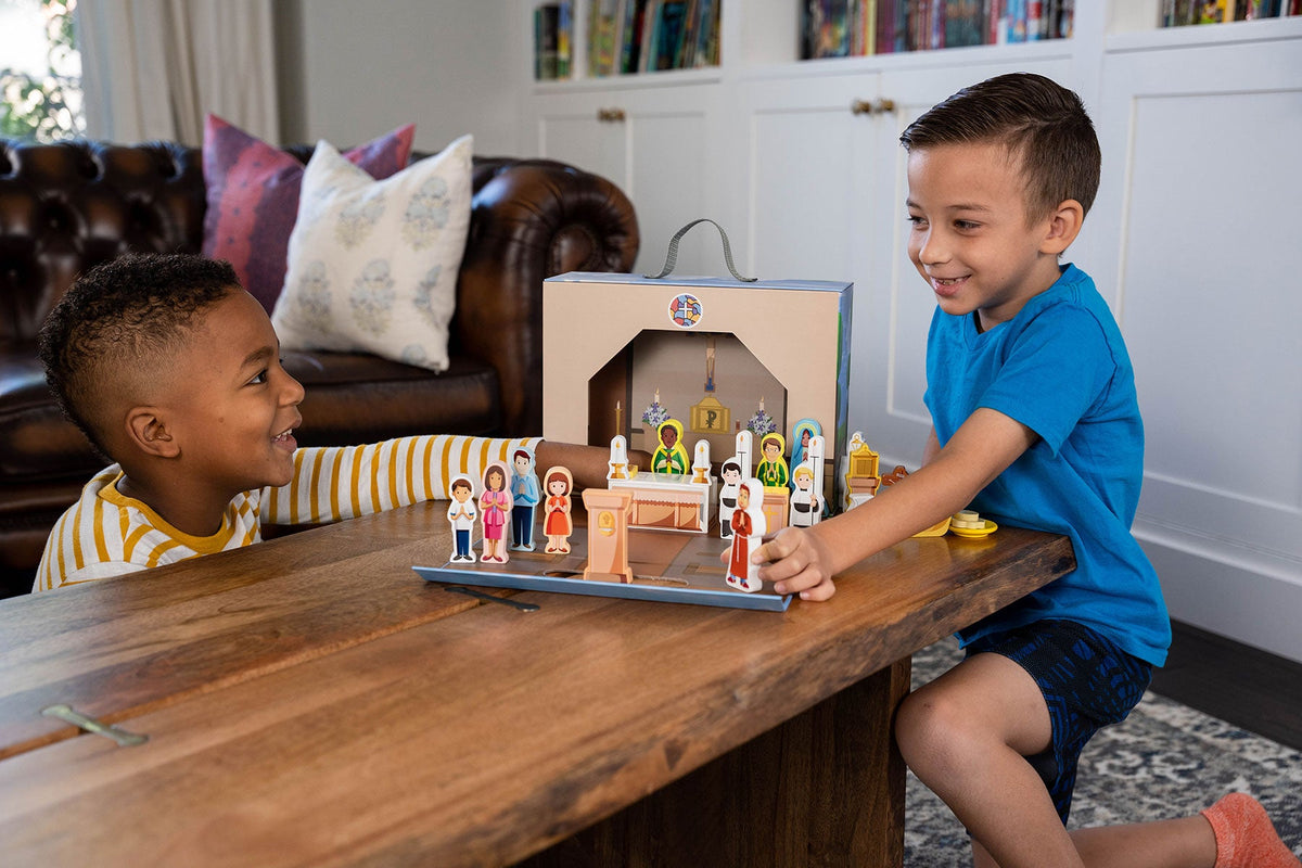 Church playset on tabletop with small saint figures; two children playing