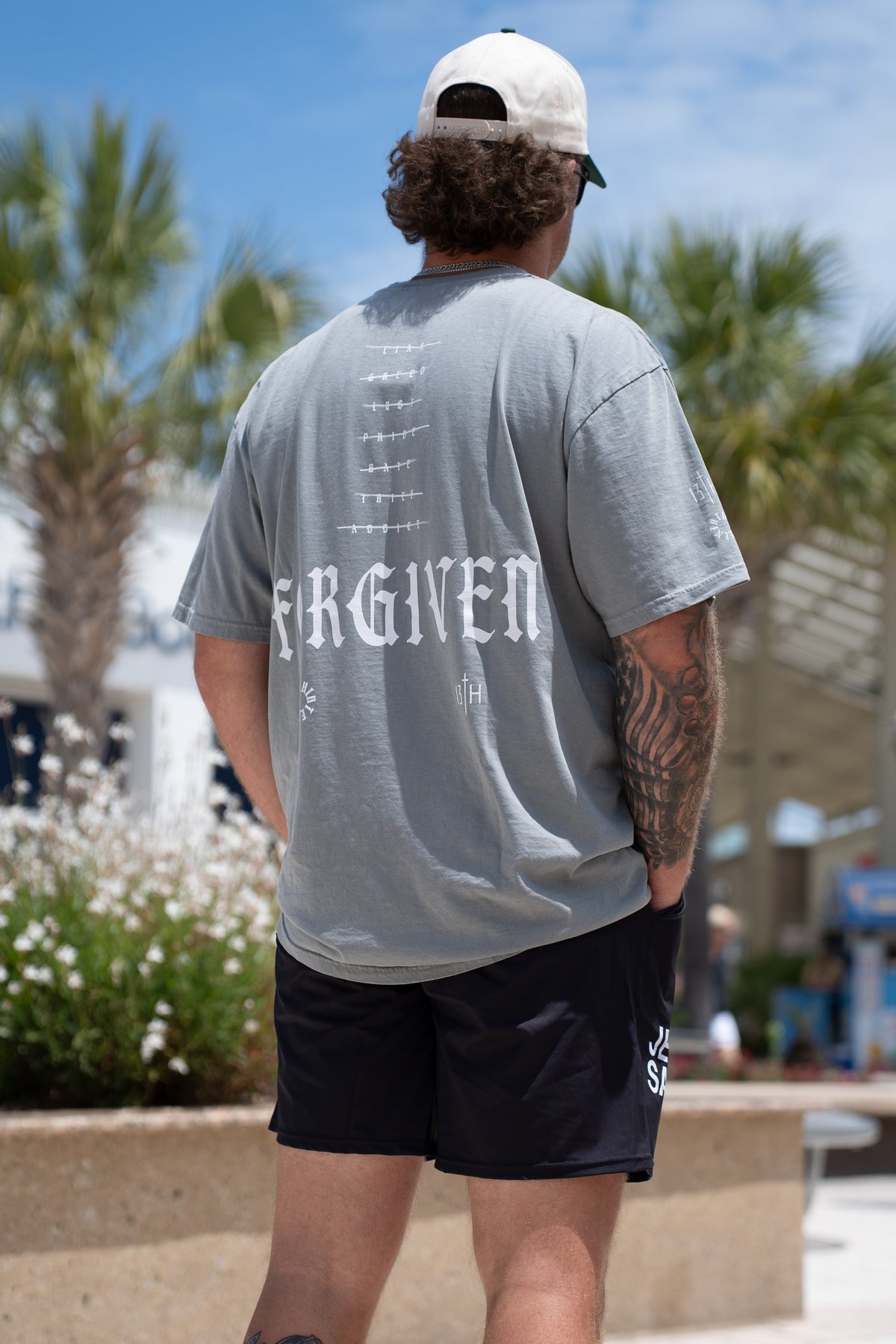 Gray premium tee with back FORGIVEN logo graphic and row of symbols, crew neck short sleeves
