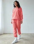 Unisex coral pink sweatpants with elastic cuffs and relaxed jogger fit
