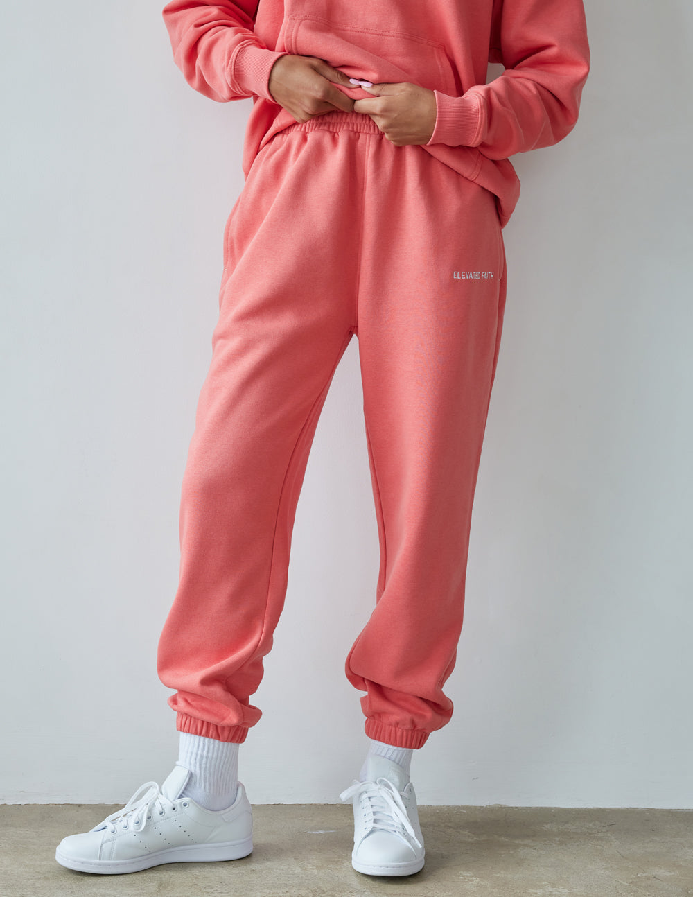 Unisex coral pink sweatpants with gathered waistband and elastic ankle cuffs