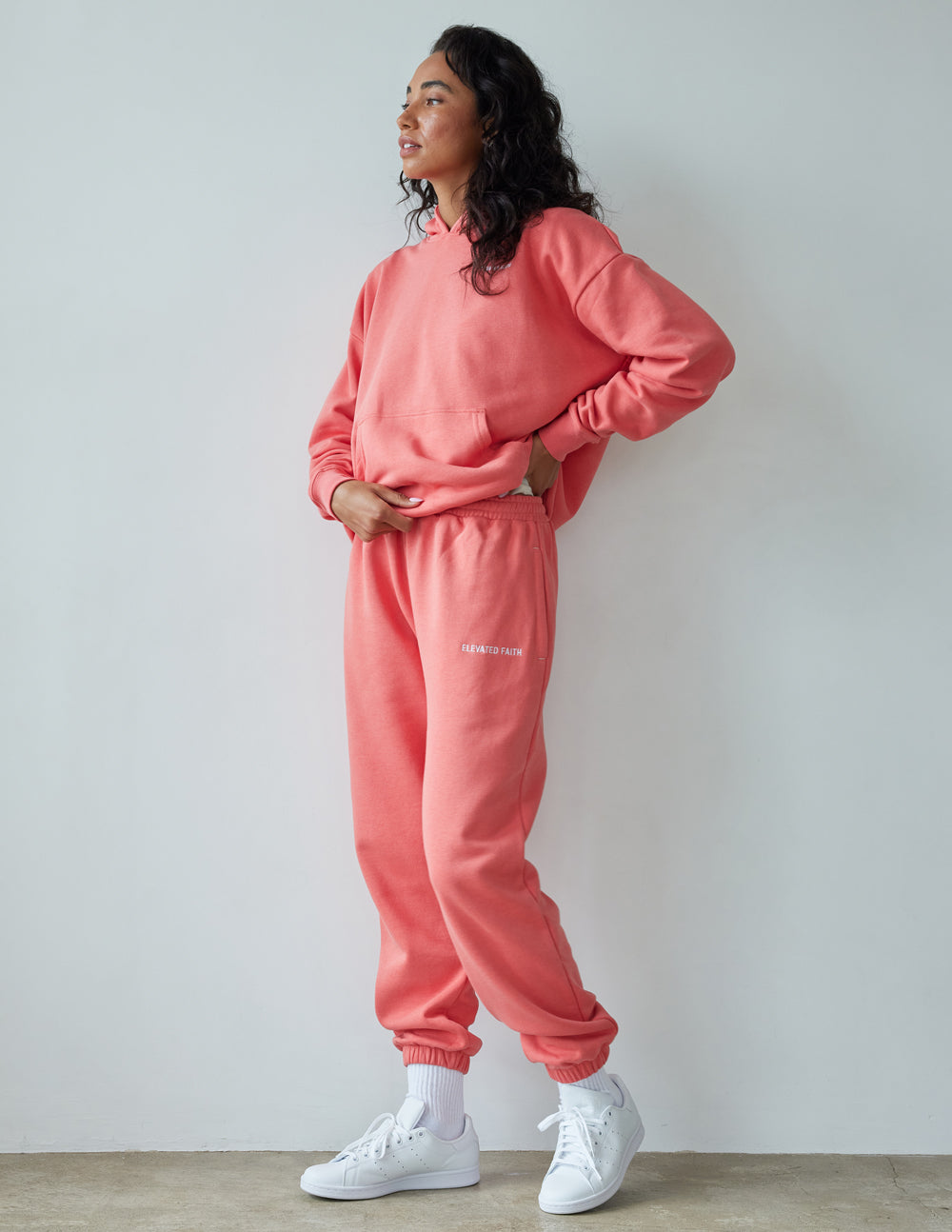 Unisex coral pink sweatpants with elastic waistband and tapered jogger leg