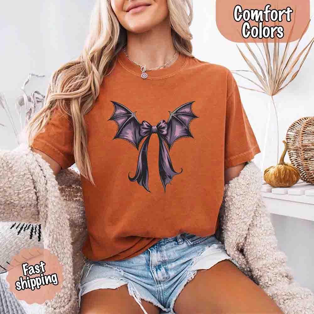 Rust brown Halloween T-shirt with black and purple bat bow graphic on front