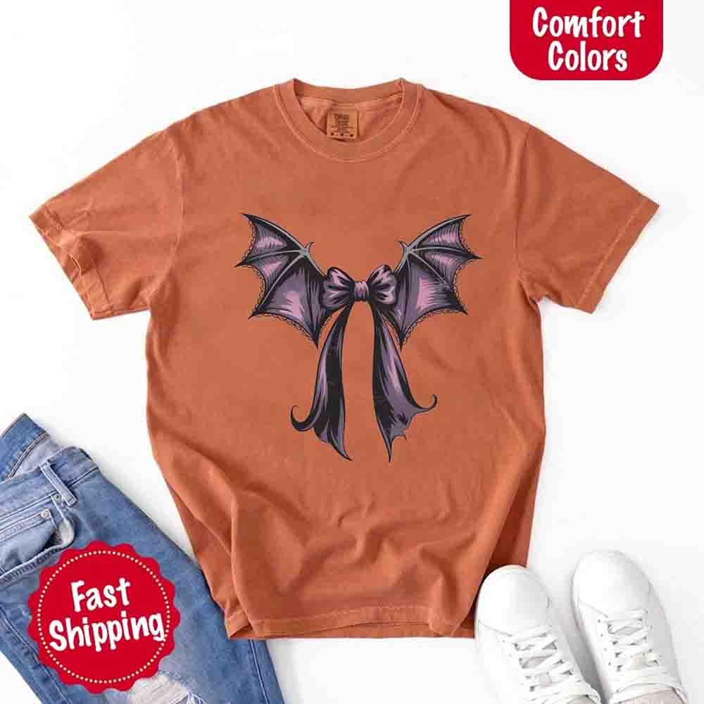 Terracotta Halloween T-shirt with black and purple bat bow graphic on chest
