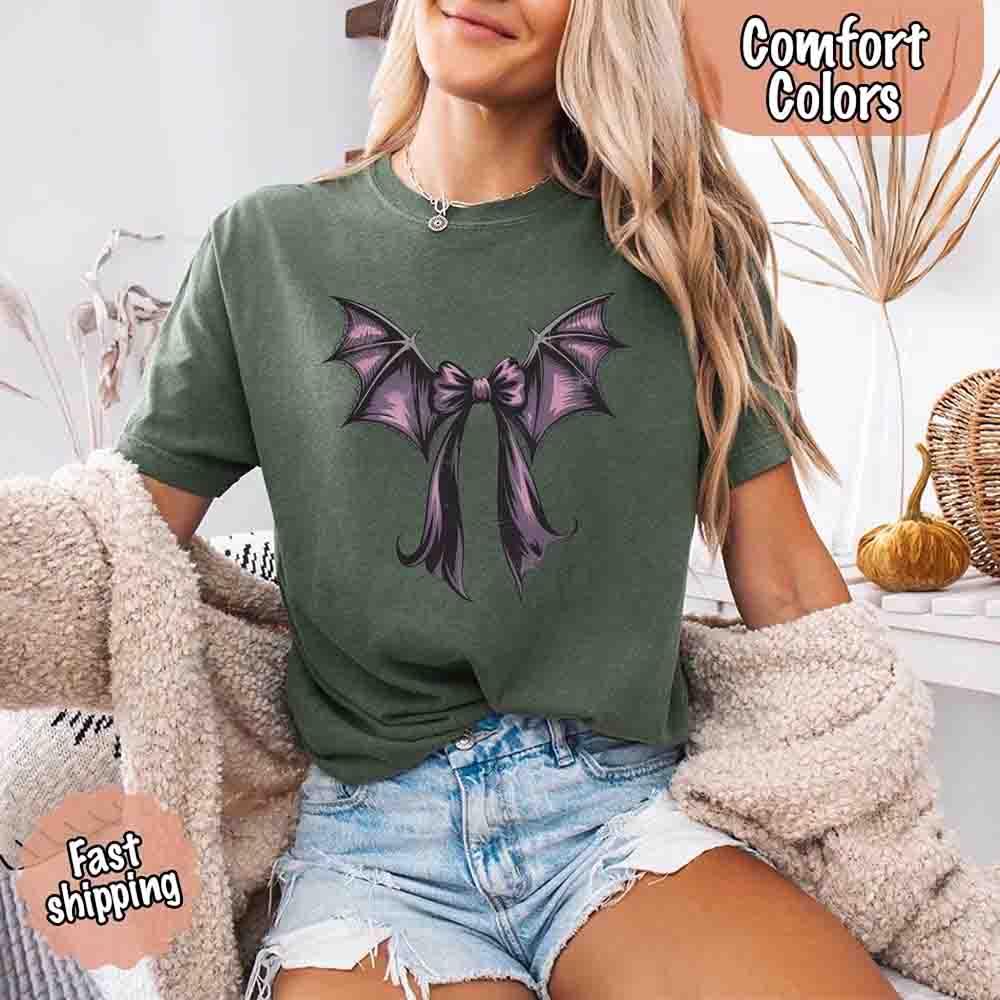 Green Halloween T-shirt with black and purple bat bow graphic across chest