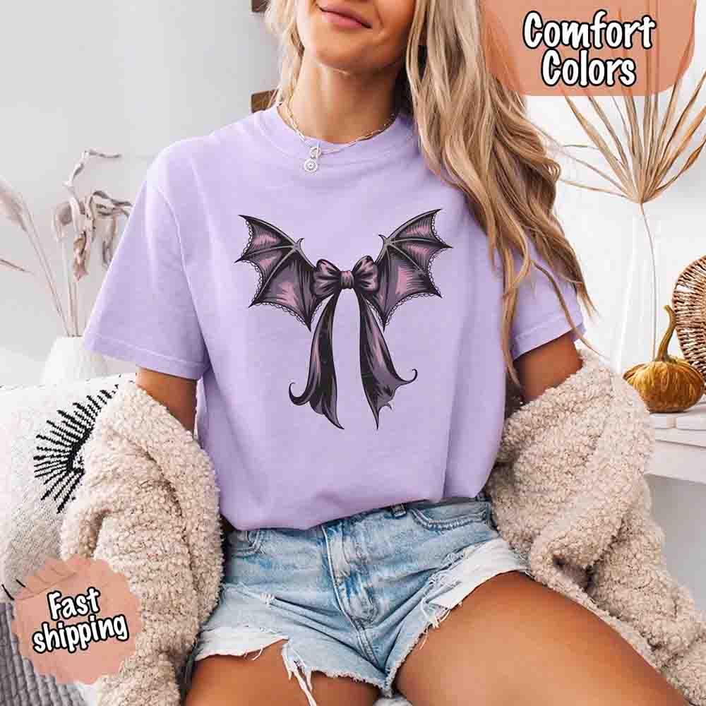Lavender purple Halloween T-shirt with black and purple bat bow graphic on front